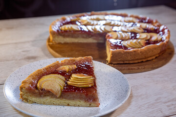 a piece of shortbread pie with apples and berry jam