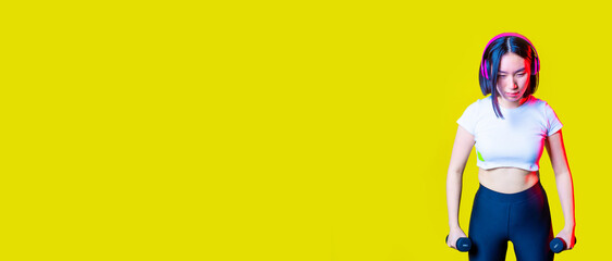 Asiatic  sportive young woman training weight lifting