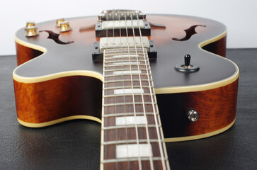 Jazz electric guitar on a light background.Close up.
