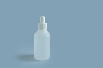 
white medicine bottle on blue background