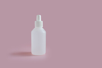 white medicine bottle on pink background