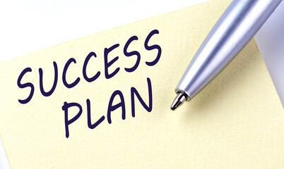 Sticky Note Message SUCCESS PLAN with pen on white background