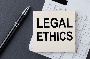 Text LEGAL ETHICS on a sticker on calculator, business concept