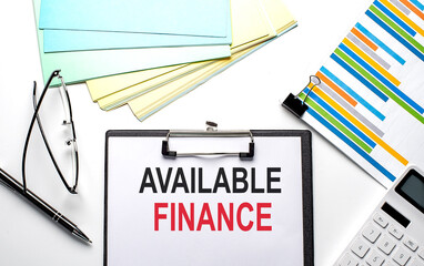 AVAILABLE FINANCE text on the paper sheet with chart,color paper and calculator