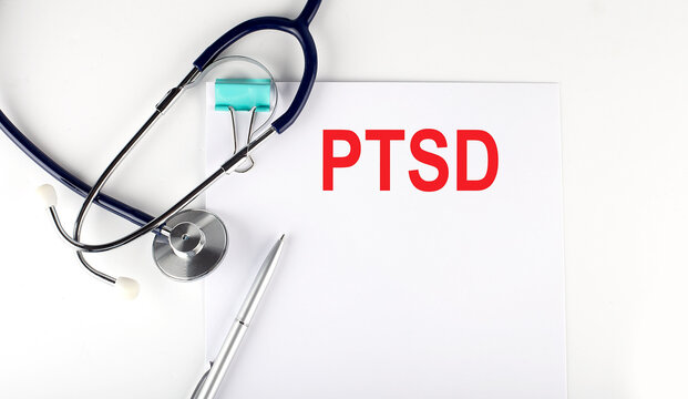 PTSD Text Written On Paper With A Stethoscope. Medical Concept.