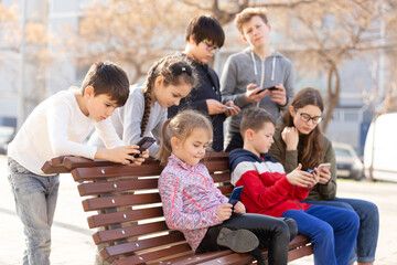 Children communicate via messengers on phones. High quality photo