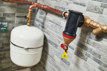 Plumbing service. copper pipeline and expansion vessel of a heating system in boiler room
