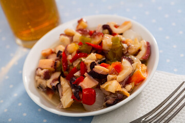 Traditional Spanish Salpicon de Marisco, cold salad from various seafood with vegetables and olives