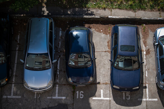 Cars parked in front of residential building. View from above. Covered parking spots. Multi floor residential buildings. Concept of transportation parking problem. 20.06.2021 Belgrade, Serbia