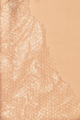 Fototapeta premium Bubble wrap on pink background with natural sunlight