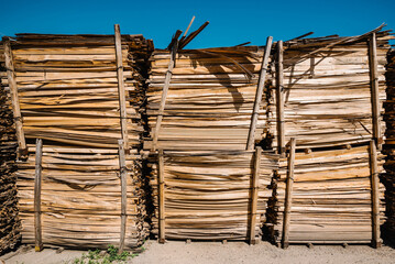 Wood waste recycle. Natural wood scraps, approach to save environment. Planks of wood as wooden texture. Abstract background from sawn wooden boards.