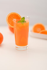 Fresh orange juice on a white table
