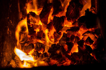 Close up photo on red coals in burning bonfire