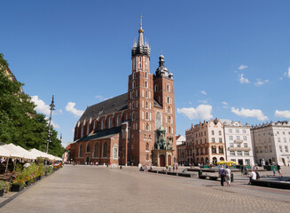 Naklejka na ściany i meble Famous Saint Mary's Basilica (Mariacki Church Kraków) at the Main Market Square in the Old Town district of Krakow, Poland.