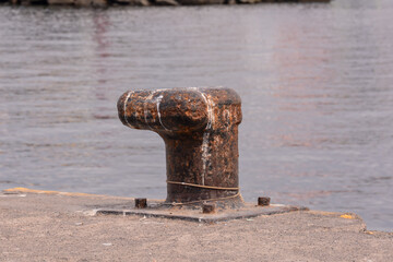 Rusty metal mooring bolard for big ship