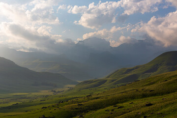 Late afternoon clouds over green valley