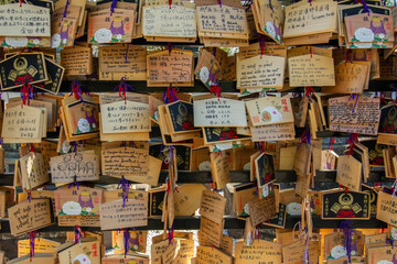 Small wooden plaques called Ema on which Japanese Shinto and Buddhist worshipers write prayers or wishes in Japan