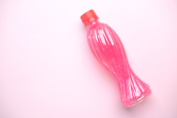 Three plastic bottles of soft drink on table 