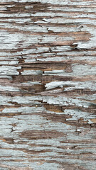 Close-up background with cracked blue paint texture on gray wood