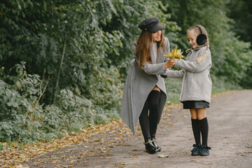 Cute and stylish family in a autumn park