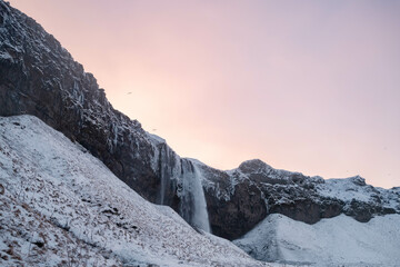 Seljalandsfoss waterfall in snowy season. Beautiful waterfall in winter in Iceland. 