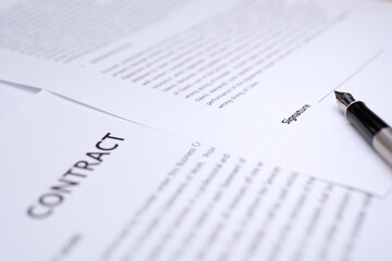 Close up of hand writing on contract 