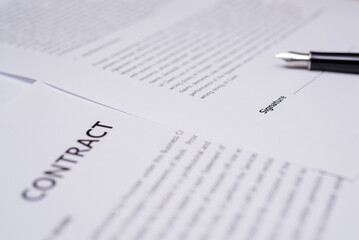 Close up of hand writing on contract 