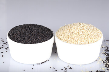 Black and white sesame seeds. An ingredient for cooking. Ayurveda treatment. Alternative medicine.