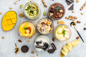 Large collection of Ice cream, delicious gelati with fresh pistachio, chocolate, caramel, melon, mango, chocolate chip sandwich cookies with aromatic vanilla pod on white