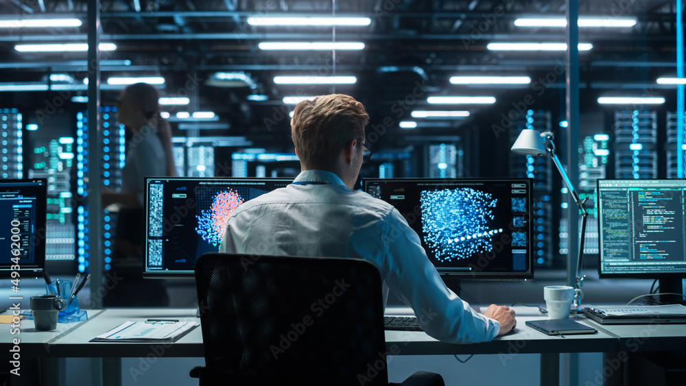 Poster In the Futuristic Laboratory or Office Male Scientists Working at the Two Monitors. Developer Writing Code at the Evening. Computer Engineer Create Neural Network at His Workstation
