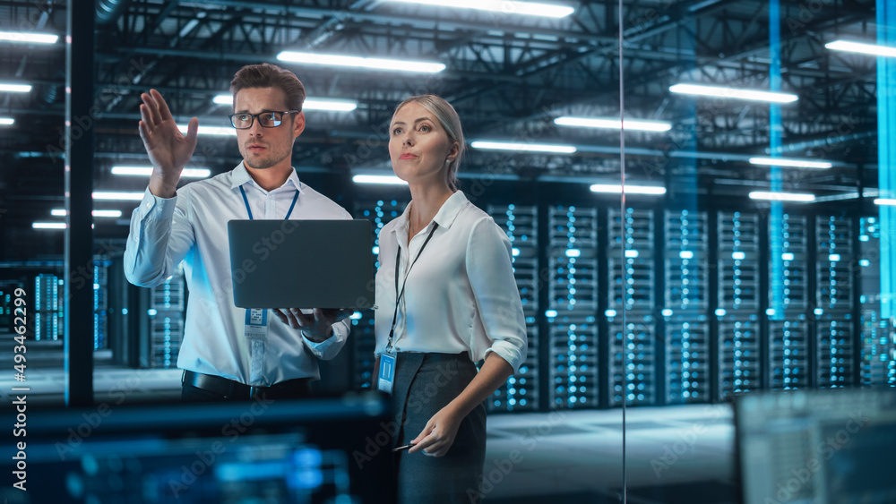 Aufkleber In Technology Research Facility: Female Project Manager Talks With Chief Engineer, they Consults with Each Other. Team of Industrial Engineers, Developers Work on Engine Design Using Computer