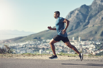 Running is one of the best ways to stay fit. Shot of a young handsome man running outdoors.