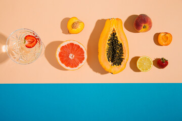 tropical summer fruits on pastel and blue background