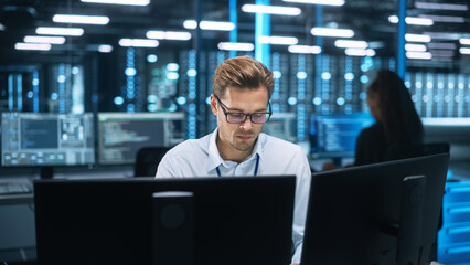 Businessman Uses Desktop Computer, while Consults with Female Project Manager about work issues In...