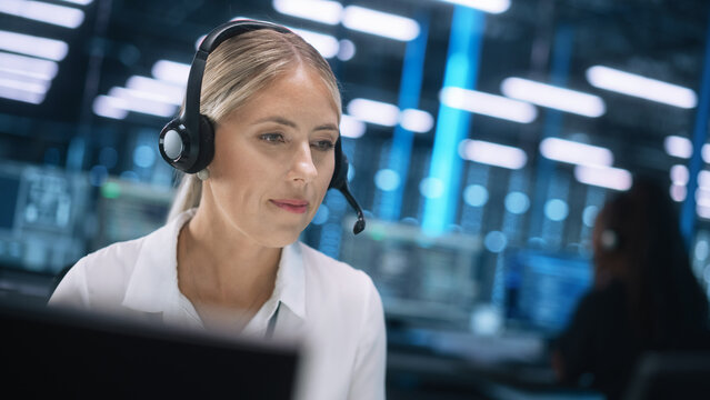 European Businesswoman Customer Support Service Agent Wearing Headset Looking at the Screen and Talk by Conference Business Call. Female manager Consult Client by Video Chat
