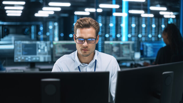 Night Office: Young Caucasian Man Working on Two Desktop Computers. Digital Entrepreneur Typing Code, Creating Modern Software, e-Commerce App Design, e-Business Programming