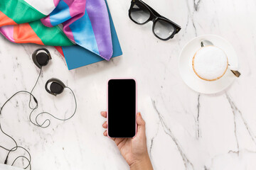 coffee glasses on the table and phone in hand