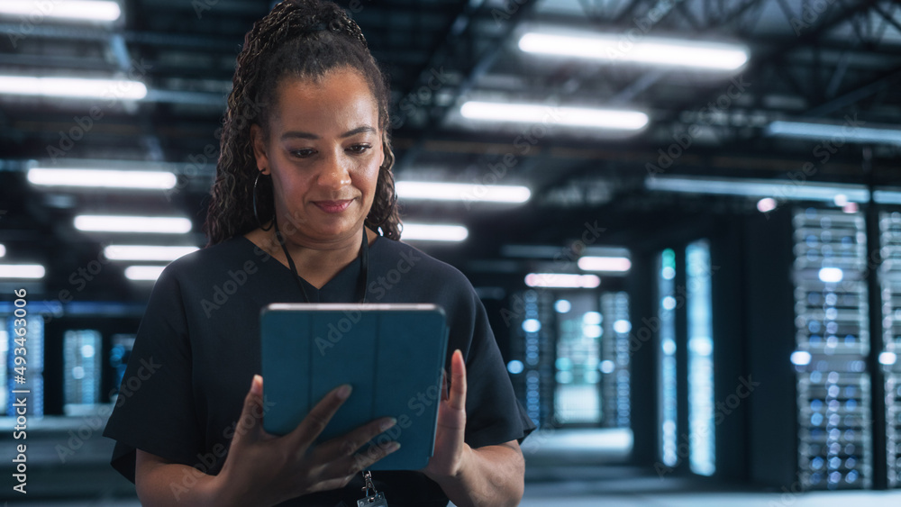 Poster Portrait of the Cheerful Female IT Specialist Using Tablet Computer in Data Center, while Smiling to the Camera. Successful Businesswoman, e-Business Entrepreneur Concept