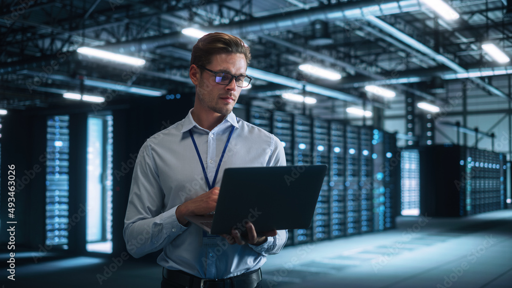 Poster Successful Male Data Center IT Specialist Look Attentively at Laptop Computer Screen, while Work with Server Farm Cloud Computing Facility. System Engineer Working for Cyber Data Security Company.