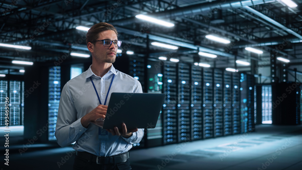 Poster Technology Research Facility: Male Project Manager Standing at the Corridor and Uses Tablet Computer. Engineers or Developers Work on Engine Design and Use Digital Computers