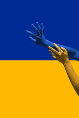 Painted in blue-yellow colors of Ukrainian flag hands gesturing isolated on bright background. Concept of help, support. Stand for Ukraine