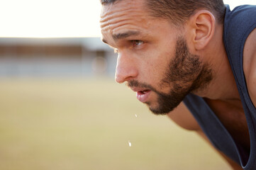 Fototapeta premium If youre not sweating, youre not working hard enough. Cropped shot of a young man looking exhausted while out for a run.
