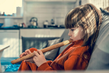 cute girl playing the flute © Igor