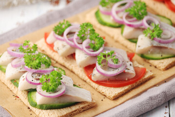 Sandwiches with herring and vegetables
