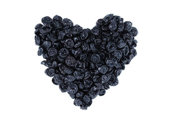 Dried prunes in the shape of  heart. White background.