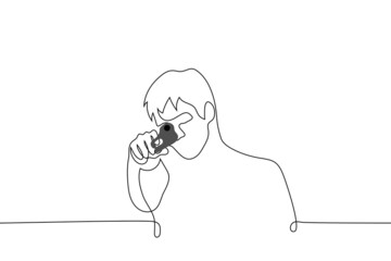 man holding a gun aimed at the viewer - one line drawing vector. shooter aiming