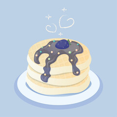 Pancakes with blackberry and decorative topping lie on the plate