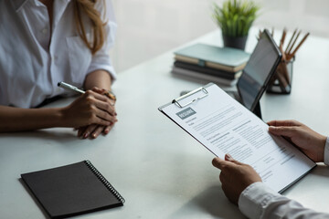 Business people hold a resume and talk to job applicants for job interviews about careers and Her personal history in the company. Recruitment concepts.