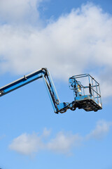 Cherry picker lift platform with telescopic arm on a building site to reach high up in construction industry
