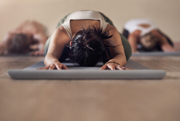 Yoga is our way of life. Shot of a group of unrecognizable people meditating and working out together in a yoga class.